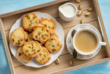 Homemade pistachio butter cookies and cup of coffee.