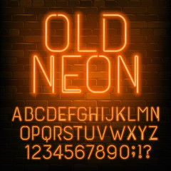 Old Neon alphabet font. Retro orange neon letters and numbers. Brick wall background. Stock vector typescript for your typography design.