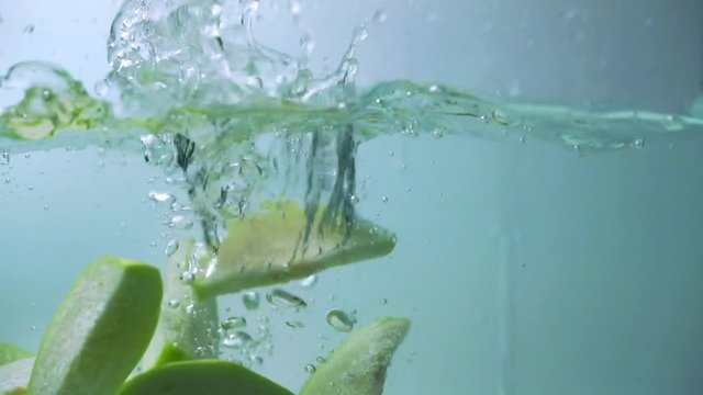 Fresh slice guava fruit fall in water splash background.
