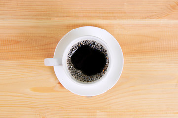 Coffee cup top view on wooden table background