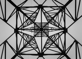 Underneath a truss pillar construction. Different geometric shapes, patterns of a steel structure....