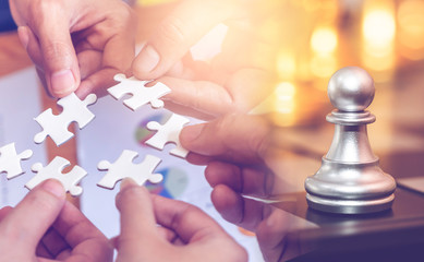 Jigsaw and chess game for business success strategy planning concept.