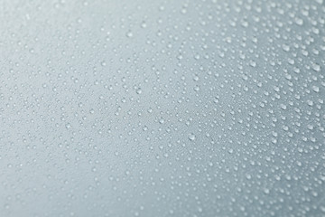 Many water drops on grey background. Texture background, close up