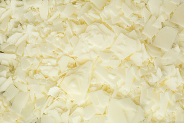 Close up of white soy wax flakes for candle making. Light texture of soy wax flakes. Ingredient for...