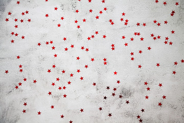 glittering red stars on a gray background