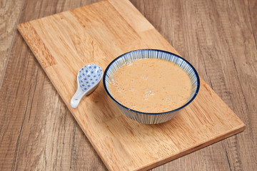 Elegant wooden tray on textured table with Day soup