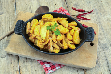 fried potatoes and chicken on a table