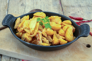 fried potatoes and chicken on a table
