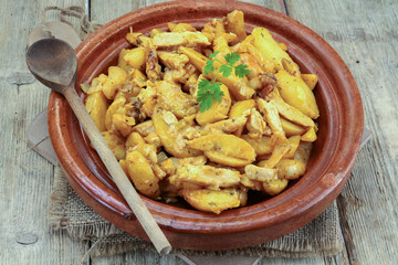fried potatoes and chicken on a table
