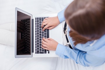 Close-up view of hands using laptop