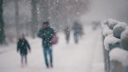 Winter street with walking peoples on heavy snow storm day under snowfall - Powered by Adobe