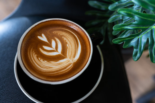 Close Up Of Latte Art Coffee On Wooden Table