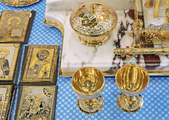 Golden wine glasses and writing materials on the table with icons.