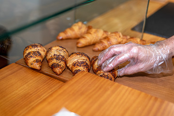 Putting bakery products on the display of a coffee shop in Madrid, Spain