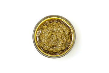 Tasty pesto sauce in bowl isolated on white background