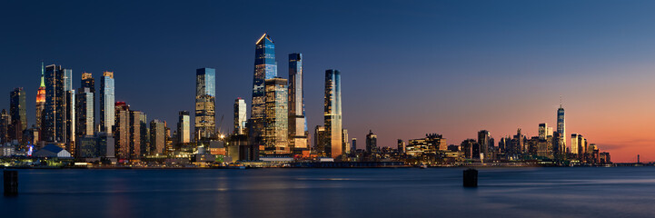 Sunset on Manhattan West with skyscrapers of Hudson Yards and the World Trade Center (Financial District). Cityscape from across the Hudson River, New York City, NY, USA