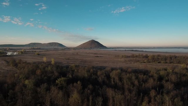 The remain of the reef of the ancient sea, composed of limestone - shikhan Yuraktau. Indian summer in the floodplain of the Belaya River. Aerial view.