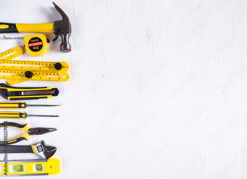 Wall mural Set of yellow construction tools on white background