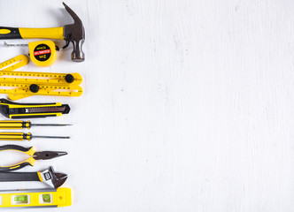Set of yellow construction tools on white background