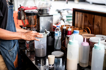 Barista prepares the coffee power to make a cup of coffee.