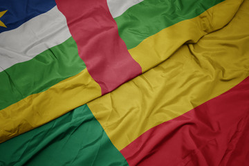 waving colorful flag of benin and national flag of central african republic.