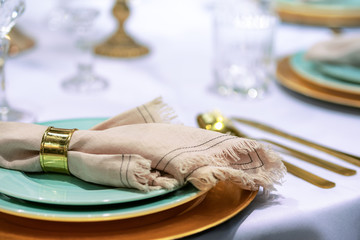 Simple and elegant wedding or festive table setting with napkin in close-up