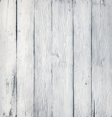 White wooden wall with vertical straps and deep, embossed texture.