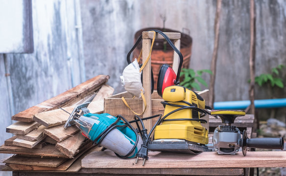 Woodworking Power Tools Including Rectangular Orbit Sander, Grinder And Jig Saw With Wooden Tool Box At Outdoor Workshop.