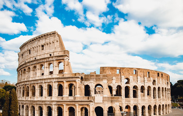 Fototapeta na wymiar Ancient ruins Colosseum Rome, Italy, background blue sky with clouds