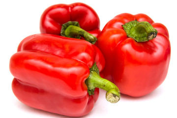 Ripe and delicious red bell peppers or paprika isolated over white background. Organic and healthy food concept. Agriculture and harvest. Vegetarian food. Supermarket banner. Selective focus.