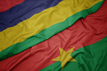 waving colorful flag of burkina faso and national flag of mauritius.