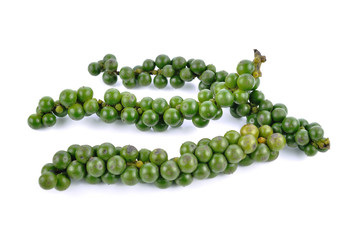 green peppercorns on white background