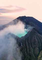 Stunning sunrise over the Ijen volcano with the beautiful turquoise-coloured acidic crater lake....