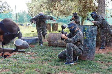 Female paintball player aiming in shootout