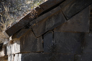 wall of a medieval church in Armenia. basalt window in a medieval church. basalt background and texture. gray texture. ancient masonry walls.