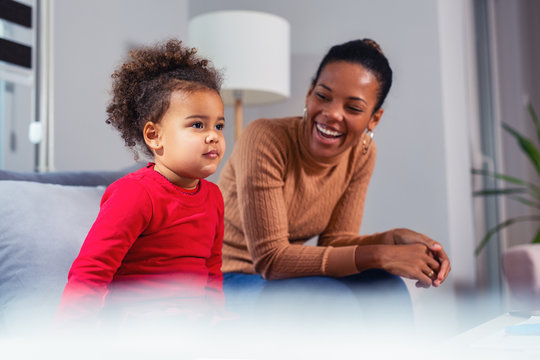 Happy mother looking at her beautiful daughter.