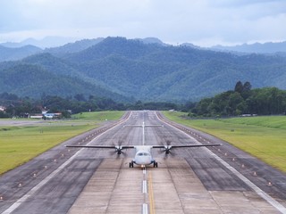 An Airplane / Aeroplane Was Taxiing, Landing, or Taking off on Runway in The Airport Surrounded by...