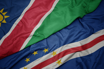waving colorful flag of cape verde and national flag of namibia.