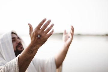 Jesus Christ praying with the scars of the nails on his hands