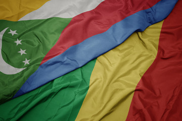 waving colorful flag of republic of the congo and national flag of comoros.