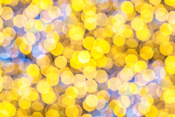 Blurred Gold Bokeh lights in the party as the abstract texture background, Golden Christmas glitter...