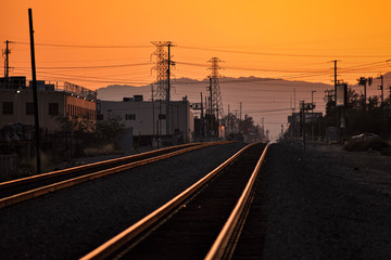 Fototapeta na wymiar railway tracks lit goldent by sunset