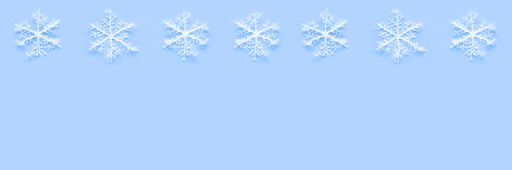 Banner of white snowflakes on blue background with copyspace. Winter holidays concept. New Year and...