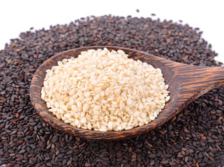white sesame seeds with wooden spoon