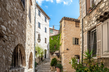 A small crowded courtyard of homes in the picturesque touristic center of the medieval village of Tourrettes Sur Loup in the South of France.