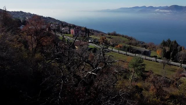 Coastal aerial panorama of Lake Garda in autumn. Close to San Zeno di Montagna and Monte Baldo clear view up to Riva.