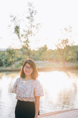 A portrait of  asian woman smiling brightly in park