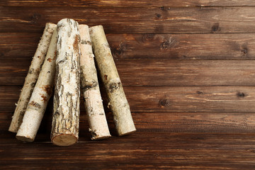 Pile of dry firewood on brown wooden table