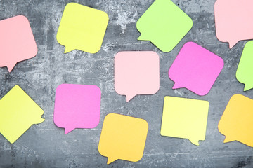 Paper speech bubbles on grey background