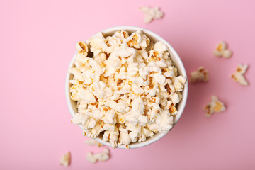 popcorn in a paper cup on a colored background